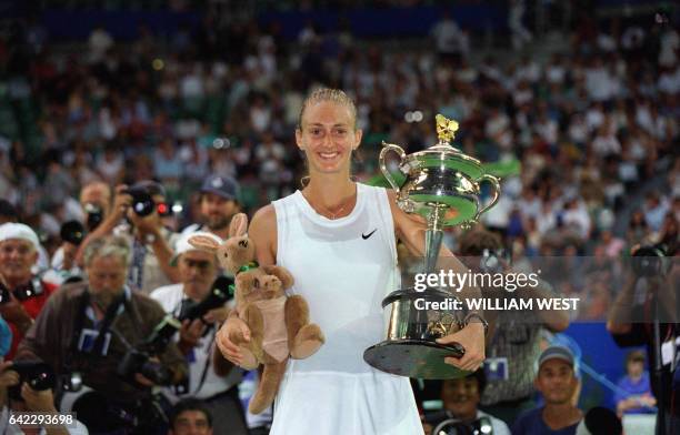 French tennis player Mary Pierce holds up the Winner's trophy after defeating Spaniard Arantxa Sanchez-Vicario in the Women's Australian Open final...