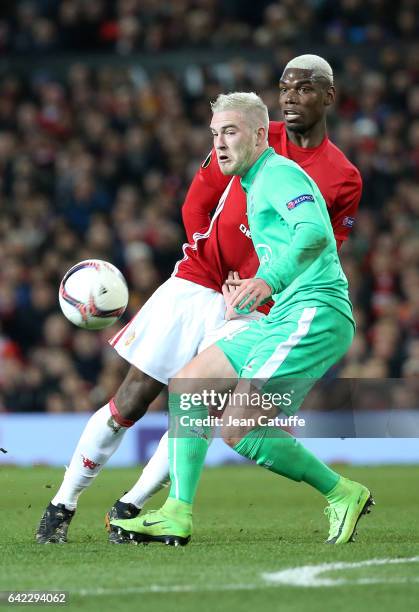 Paul Pogba of Manchester United and Jordan Veretout of Saint-Etienne in action during the UEFA Europa League Round of 32 first leg match between...