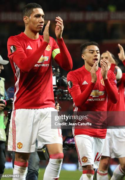 Chris Smalling and Jesse Lingard of Manchester United thanks the fans following the UEFA Europa League Round of 32 first leg match between Manchester...