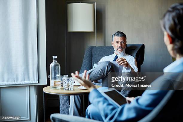 businessman and colleague at meeting at hotel room - businessman hotel ストックフォトと画像