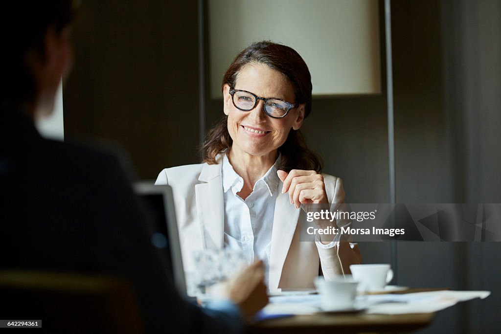 Businesswoman looking at colleague during meeting