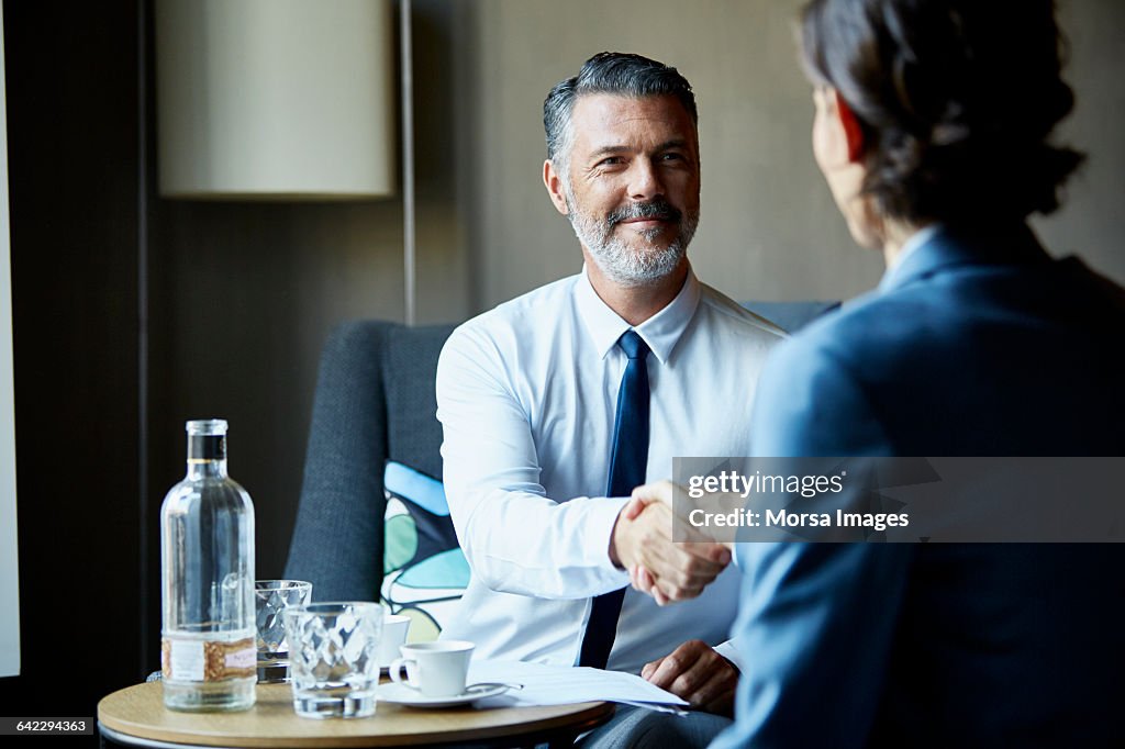 Business people shacking hands after meeting