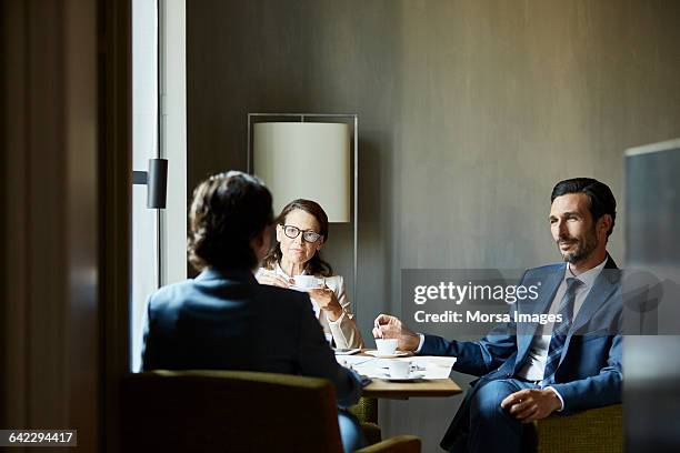 business people during meeting in hotel room - abbigliamento da lavoro formale foto e immagini stock