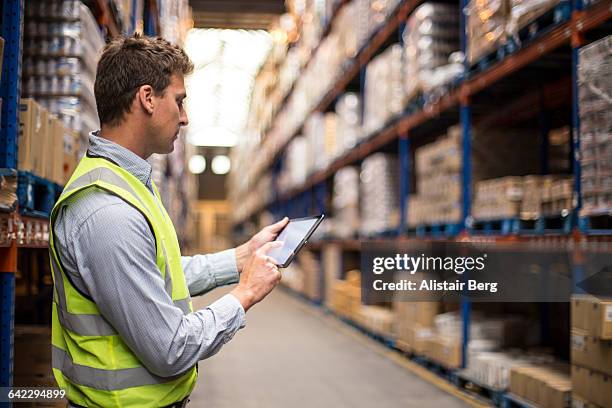 worker inside a food distribution warehouse - distribution warehouse stock-fotos und bilder