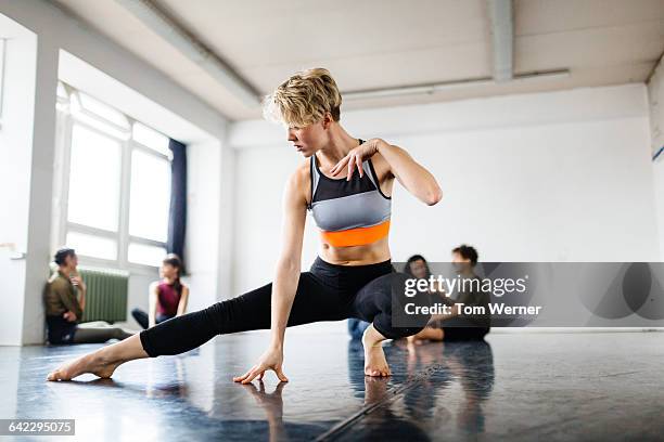 female dancer exercising in a dancing studio - modern dance stock-fotos und bilder