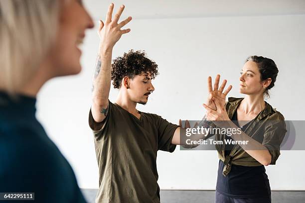 female teacher correcting her student - dance teacher foto e immagini stock