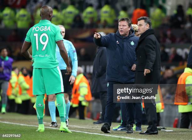 Assistant coach of Saint-Etienne Thierry Oleksiak and coach of Saint-Etienne Christophe Galtier give their instructions to Florentin Pogba during the...