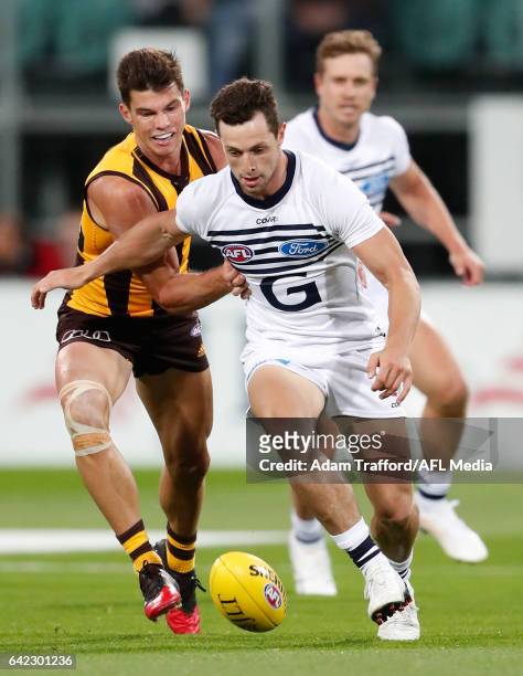 Jaeger O'Meara of the Hawks and Darcy Lang of the Cats compete for the ball during the AFL 2017 JLT Community Series match between the Hawthorn Hawks...