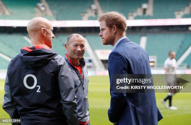 Britain's Prince Harry speaks with England Coach Eddie Jones during a visit to an England Rugby squad training session at Twickenham stadium in...