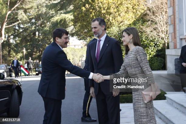 In this handout photo provided by Casa de S.M. El Rey de Espana, Hungarian President Janos Ader , shakes hands with Queen Letizia of Spain as King...