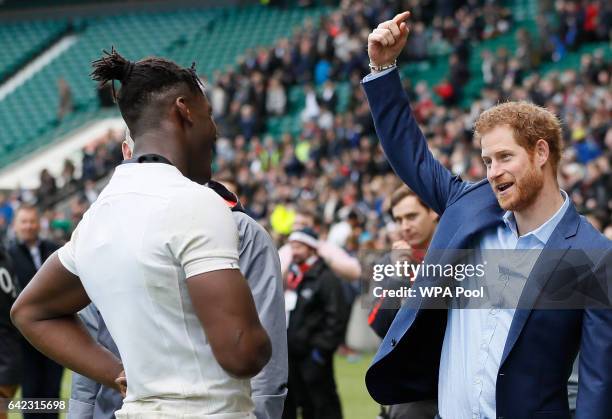 Britain's Prince Harry, right, speaks with England player Maro Itoje during a visit to an England Rugby Squad training session at Twickenham Stadium...