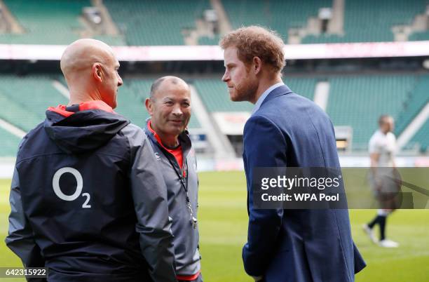 Britain's Prince Harry, speaks with England Coach Eddie Jones, during a visit to an England Rugby Squad training session at Twickenham Stadium on...