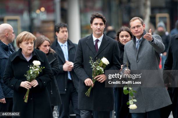 German Chancellor Angela Merkel , Canadian Prime Minister Justin Trudeau and Mayor of Berlin Michael Mueller prepare to lay flowers at a memorial to...