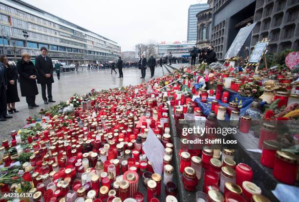 German Chancellor Angela Merkel and Canadian Prime Minister Justin Trudeau pause after laying flowers at a memorial to the victims of the December...