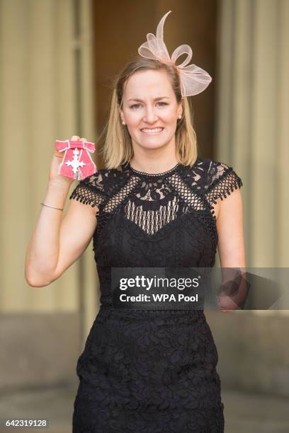 Paralympic swimmer Claire Cashmore poses after receiving her MBE medal from the Prince of Wales at Buckingham Palace on February 17, 2017 in London,...