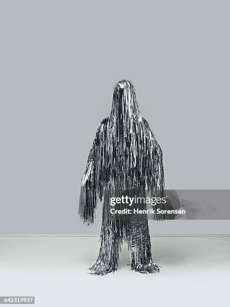 human figure created by christmas tinsel - tinsel stock-fotos und bilder