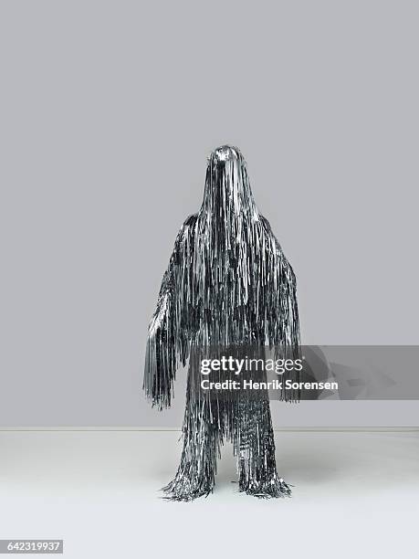 human figure created by christmas tinsel - tinsel stock pictures, royalty-free photos & images