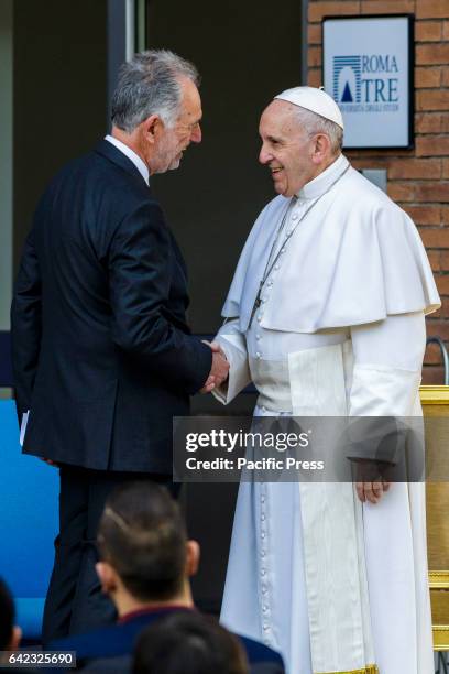 Pope Francis shakes hands with the Rector of the University and Architect Mario Panizza as he visits the Roma Tre University, one of Rome's three...