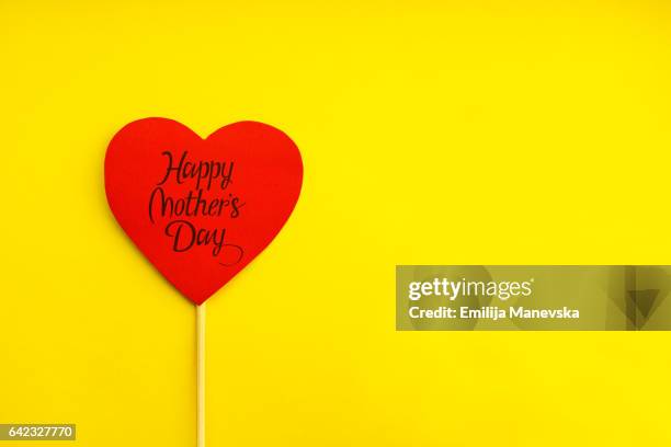 happy mother's day. red paper heart on yellow background - 2012 stock pictures, royalty-free photos & images