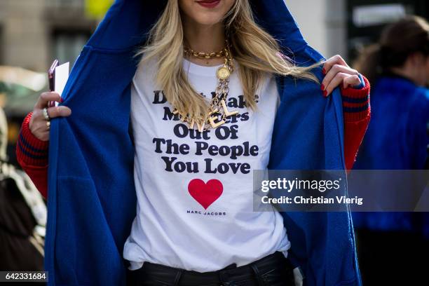 Chiara Ferragni wearing wearing a Gucci beanie, a white tshirt, red college jacket, black cropped leather pants, glasses outside Marc Jacobs on...