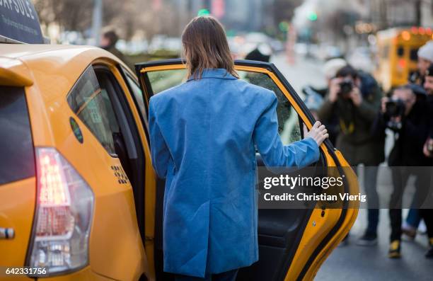 Anya Ziourova wearing a blue suit, velvet knit outside Marc Jacobs on February 16, 2017 in New York City.