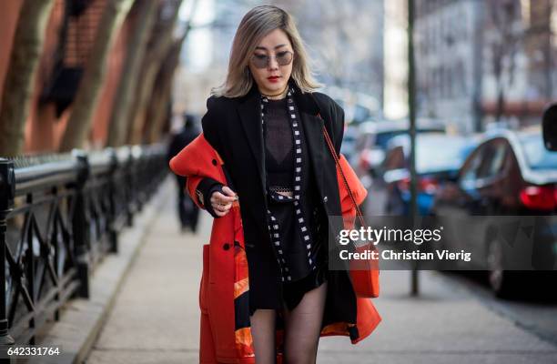 Guest wearing a black blazer, tights outside Marc Jacobs on February 16, 2017 in New York City.