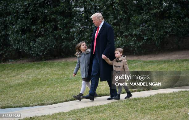 President Donald Trump walks with grandchildren Arabella Kushner and Joseph Kushner to board Marine One from the South Lawn of the White House on...