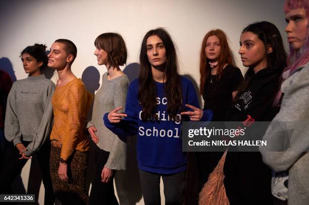 Models are prepared backstage before a catwalk show by Turkish fashion designer Bora Aksu on the first day of the Autumn/Winter 2017 London Fashion...