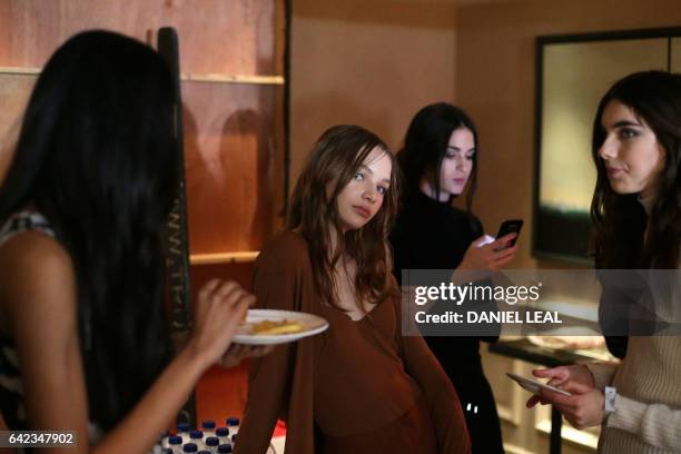 Models are prepared backstage before a catwalk show by DAKS on the first day of the Autumn/Winter 2017 London Fashion Week in London on 17 February...