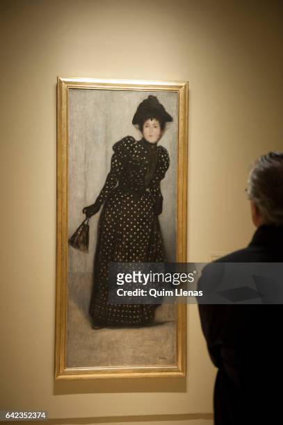 Visitor looks at the paint 'Mujer con vestido de lunares blancos' by Jozsef Rippi.Ronai during the press preview of the exhibition 'Obras maestras de...