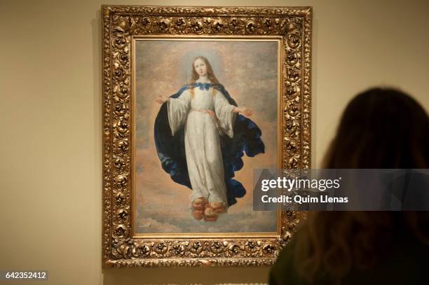 Visitor looks at the paint 'La Inmaculada Concepcion' by Francisco de Zurbaran during the press preview of the exhibition 'Obras maestras de...