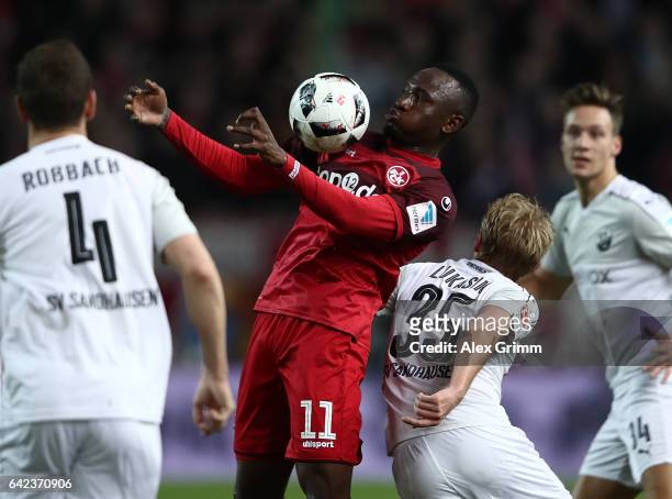 Jacques Zoua Daogari of Kaiserslautern is challenged by Daniel Lukasik of Sandhausen during the Second Bundesliga match between 1. FC Kaiserslautern...
