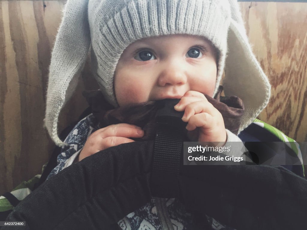 Young baby wearing warm hat with rabbit ears