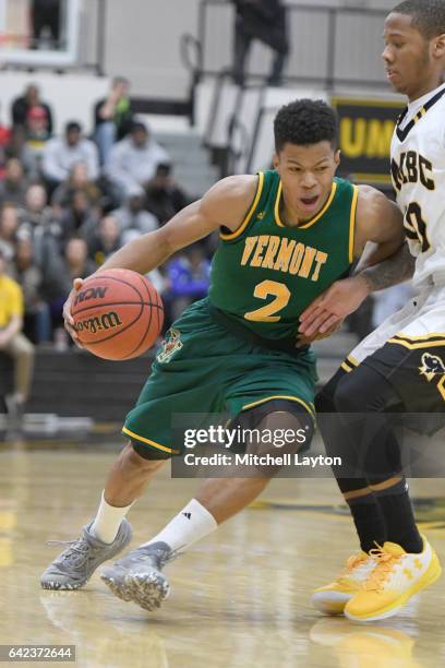 Trae Bell-Haynes of the Vermont Catamounts dribbles the ball during a college basketball game against the UMBC Retrievers at the RAC Arena on...