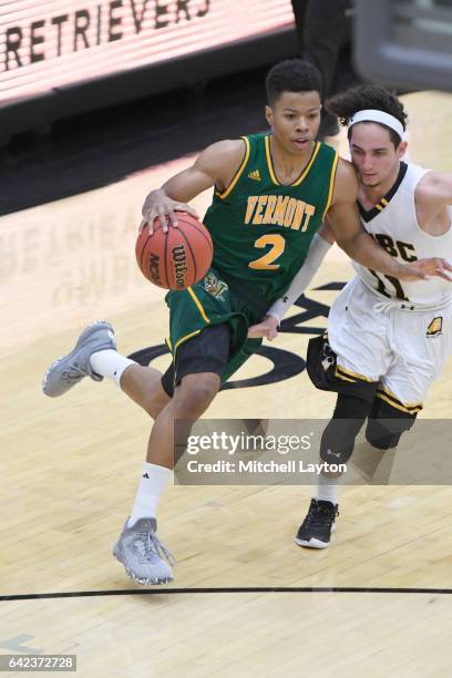 Trae Bell-Haynes of the Vermont Catamounts dribbles the ball during a college basketball game against the UMBC Retrievers at the RAC Arena on...