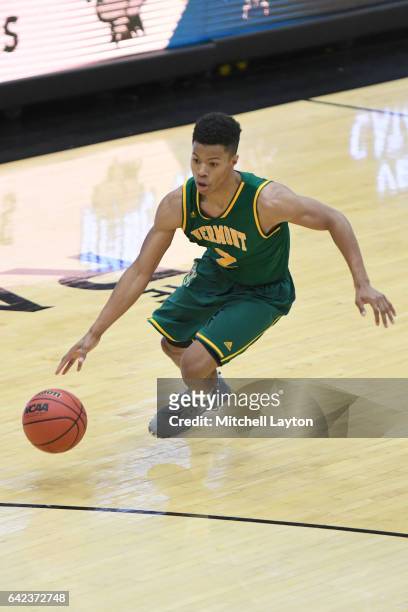 Trae Bell-Haynes of the Vermont Catamounts dribbles the ball during a college basketball game against the UMBC Retrievers at the RAC Arena on...