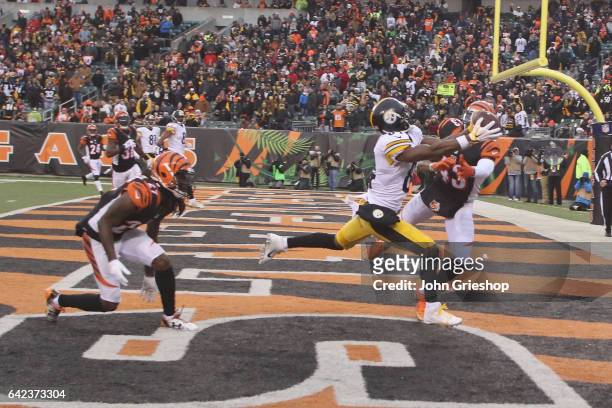 Antonio Brown of the Pittsburgh Steelers goes up for the pass against George Iloka of the Cincinnati Bengals during their game at Paul Brown Stadium...