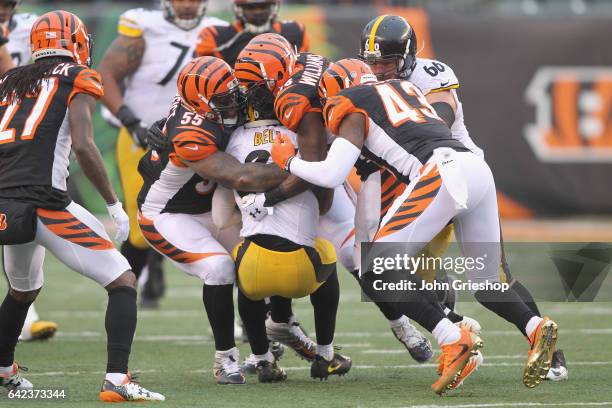 Le'Veon Bell of the Pittsburgh Steelers runs the football upfield against Vontaze Burfict and George Iloka of the Cincinnati Bengals during their...