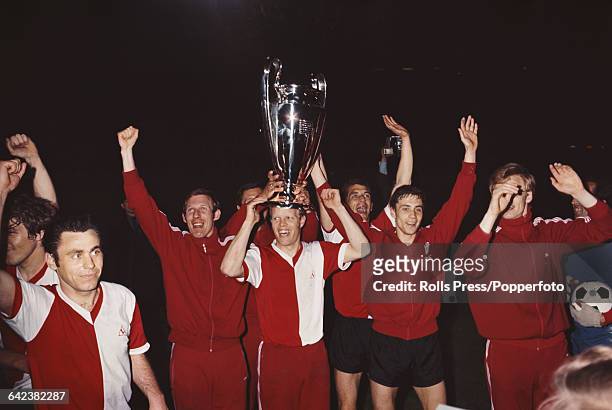 Players and team members of the Dutch football club Feyenoord celebrate with the trophy after beating Celtic 2-1 after extra time in the final of the...