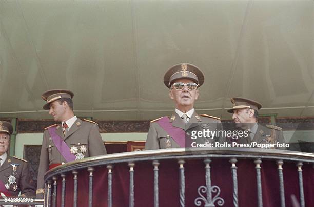 President of Spain, General Francisco Franco stands wearing full military dress uniform and sunglasses, together with Prince of Spain, Juan Carlos de...