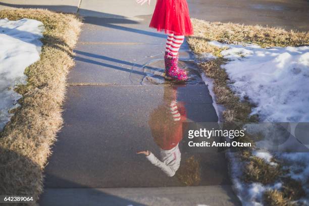Girl Standing in Puddle