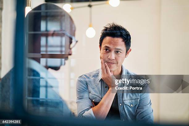 serious businessman listening to coworker - man in office concentrating stock pictures, royalty-free photos & images