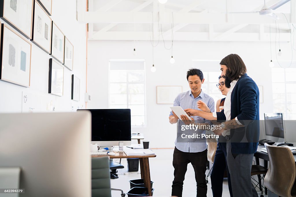 Creative business people using digital tablet