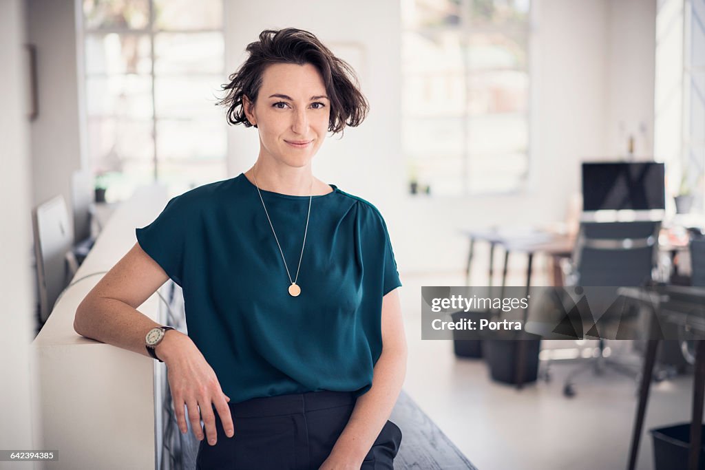 Smiling businesswoman in creative office