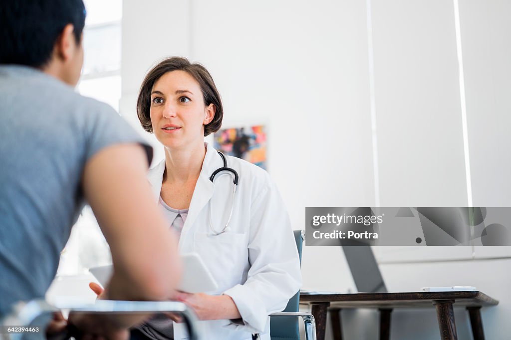 Female doctor going over test results with patient