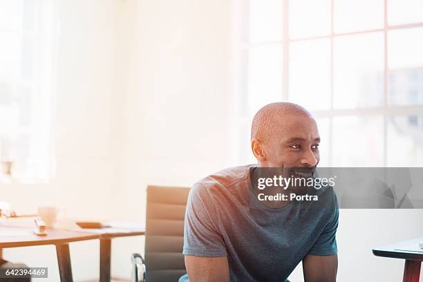 thoughtful happy businessman in office - brightly lit stock-fotos und bilder