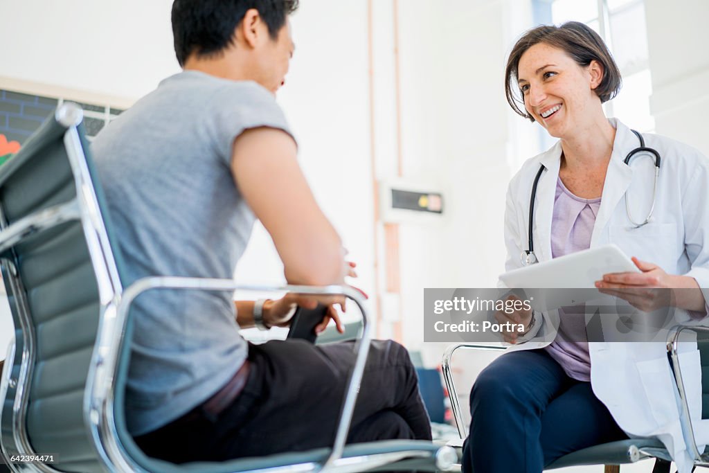 Happy female doctor with patient in hospital