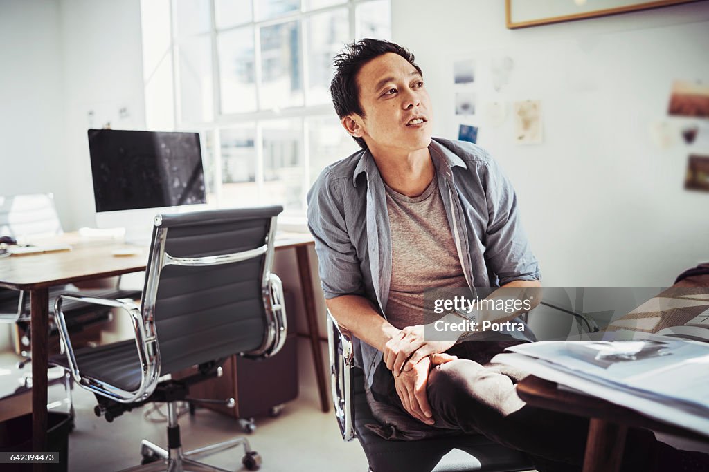 Thoughtful businessman sitting on chair