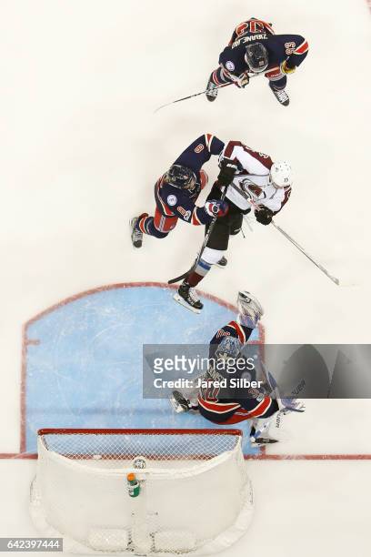 Henrik Lundqvist of the New York Rangers makes a save as Kevin Klein defends against Mikhail Grigorenko of the Colorado Avalanche at Madison Square...