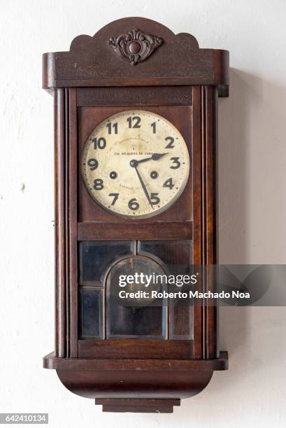 Cuban vintage objects: Old colonial wall clock. The items are preserved in 'La Periquera' building which is a tourist attraction in Holguin city.